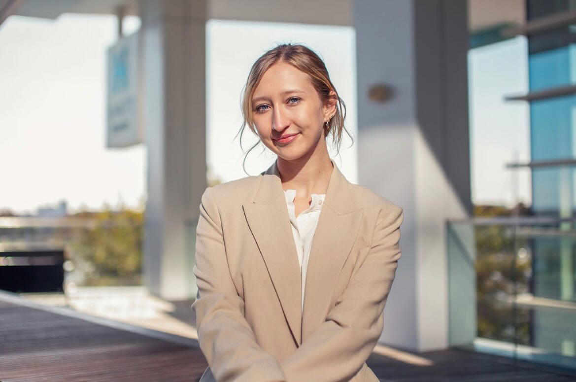 Professional Profile Shot of Emma Potter wearing a tan suit jacket